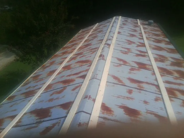 Rusted metal roof panels with new wood purlins before replacement — Storm Damage Roof Repair in San Pablo by Roofing Brothers
