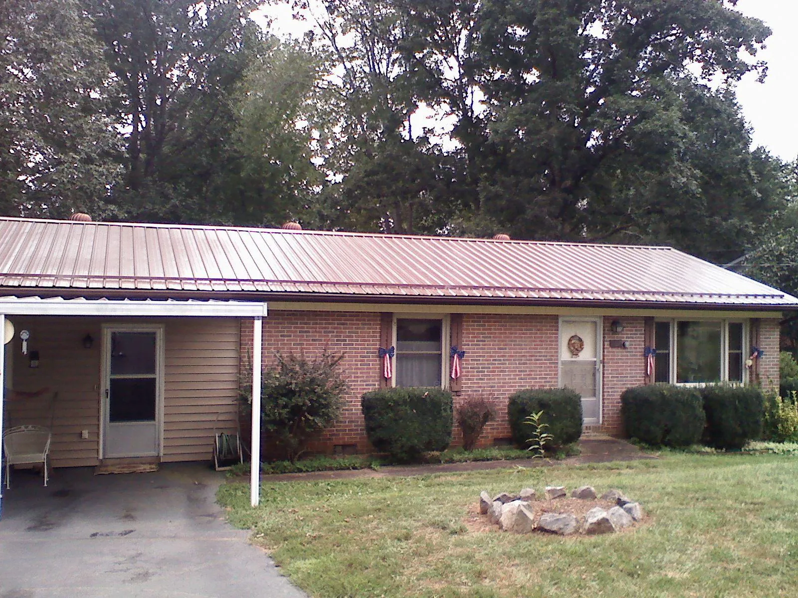 Bronze metal roof and carport on a brick ranch home — Roof Repair work by our crew in San Pablo